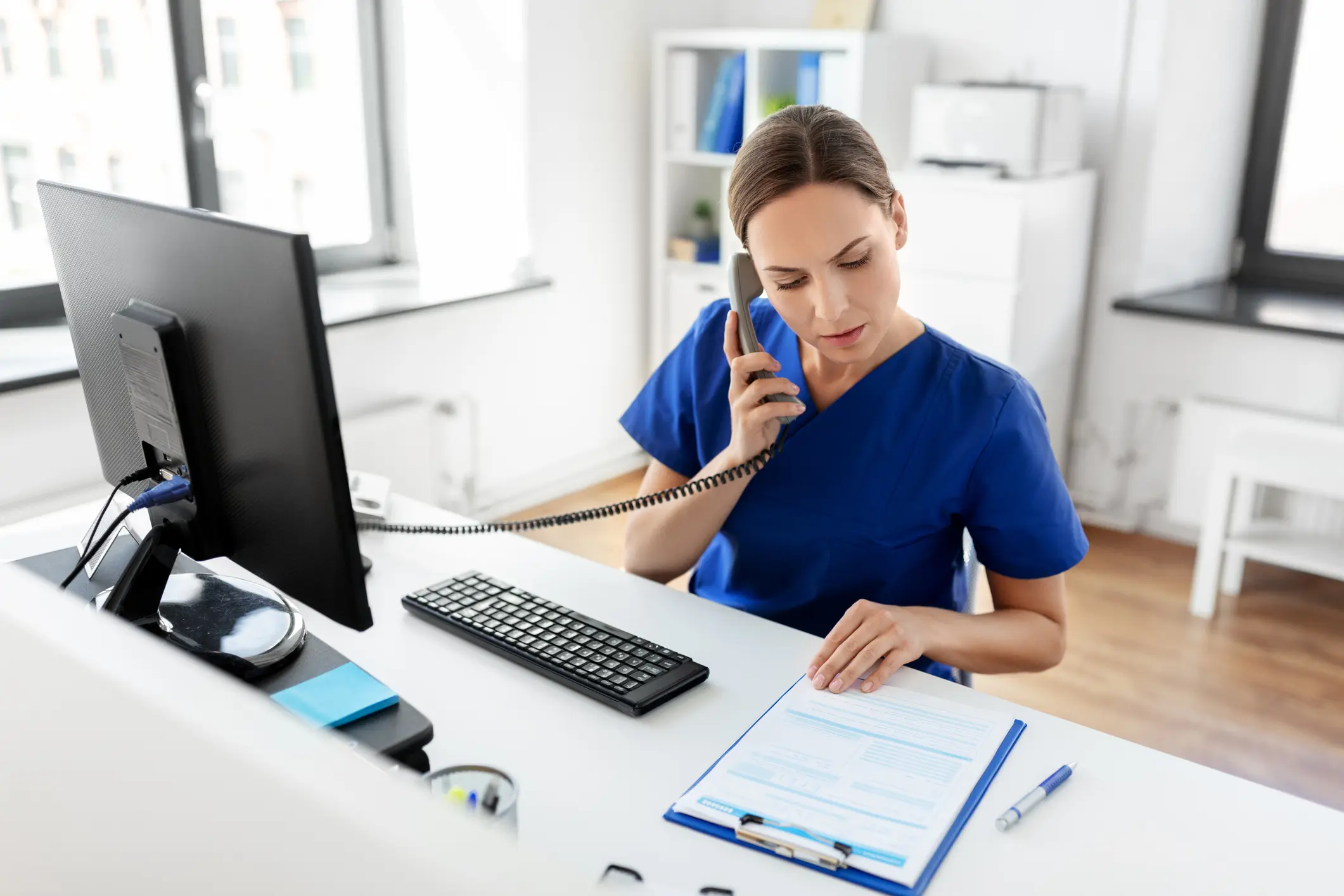Staff overwhelmed juggling patient check-ins while phones ring endlessly, leading to errors and frustrated patients